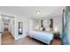Bright bedroom with a king-size bed and hardwood floors at 3067 S Holly Pl, Denver, CO 80222