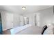 Spacious bedroom with a large bed, access to closets, and hardwood floors at 3067 S Holly Pl, Denver, CO 80222