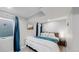 Basement bedroom with a queen-size bed and teal bedding at 3067 S Holly Pl, Denver, CO 80222
