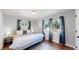 Spacious bedroom with a king-size bed and hardwood floors at 3067 S Holly Pl, Denver, CO 80222