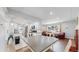 Open concept dining area with a grey table and chairs, adjacent to the kitchen and living room at 3067 S Holly Pl, Denver, CO 80222