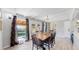 Bright dining room with backyard access and wood floors at 3067 S Holly Pl, Denver, CO 80222