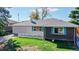 Ranch style home with brick exterior, attached garage, and a well-manicured lawn at 3067 S Holly Pl, Denver, CO 80222