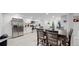 Modern basement kitchen with stainless steel appliances and breakfast bar at 3067 S Holly Pl, Denver, CO 80222