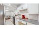 Modern kitchen with white cabinets and granite countertops at 3067 S Holly Pl, Denver, CO 80222