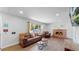 Living room with hardwood floors, fireplace, and a large TV at 3067 S Holly Pl, Denver, CO 80222