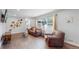 Living room with hardwood floors, comfortable seating, and a fireplace at 3067 S Holly Pl, Denver, CO 80222
