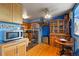 Kitchen with dining area and wood cabinets, stainless steel appliances, and hardwood floors at 1350 Josephine St # 401, Denver, CO 80206