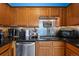 Modern kitchen with wood cabinets, granite counters, and stainless steel appliances at 1350 Josephine St # 401, Denver, CO 80206