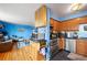 Open concept kitchen and living room with hardwood floors and blue walls at 1350 Josephine St # 401, Denver, CO 80206