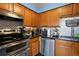 Modern kitchen with wood cabinets, granite counters, and stainless steel appliances at 1350 Josephine St # 401, Denver, CO 80206