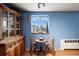 Small dining area with wood table and chairs, near a window at 1350 Josephine St # 401, Denver, CO 80206