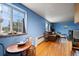Living room with hardwood floors, blue walls, and a brown leather couch at 1350 Josephine St # 401, Denver, CO 80206