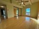 Bright bedroom with hardwood floors, mirrored closet doors, and a ceiling fan at 8060 E Girard Ave # 901, Denver, CO 80231