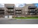 Condo building exterior with parking and landscaping at 6000 W Floyd Ave # 107, Denver, CO 80227