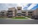 Exterior of an apartment building with multiple balconies and landscaping at 6000 W Floyd Ave # 107, Denver, CO 80227