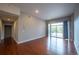 Bright living room with hardwood floors and sliding glass doors to patio at 6000 W Floyd Ave # 107, Denver, CO 80227
