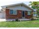 Brick ranch house with a well-maintained lawn at 177 Wolff St, Denver, CO 80219