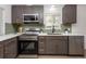 Modern kitchen with stainless steel appliances and updated cabinetry at 177 Wolff St, Denver, CO 80219