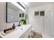 Updated bathroom with a white vanity and walk-in shower at 177 Wolff St, Denver, CO 80219