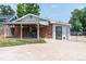 Brick home with covered patio, detached shed, and fenced yard at 177 Wolff St, Denver, CO 80219