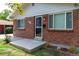 Brick ranch house with a front entry and landscaped yard at 177 Wolff St, Denver, CO 80219