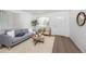 Bright living room with gray sofa and wooden coffee table at 177 Wolff St, Denver, CO 80219