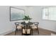Small dining area with a round black table and four chairs at 177 Wolff St, Denver, CO 80219