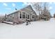 Lovely home with backyard patio and snowy landscape at 6679 S Robb St, Littleton, CO 80127