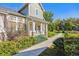 Two story home with walkway, landscaping and partial view of backyard at 5155 W Quincy Ave # E104, Denver, CO 80236