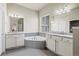 Bathroom boasts double sinks, a soaking tub, and tile flooring at 10790 E 163Rd Ct, Brighton, CO 80602