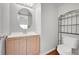 Small bathroom with toilet, sink, and decorative shelving at 19873 E Vassar Ave, Aurora, CO 80013