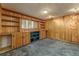 Finished basement room with built-in shelving and wood paneling at 6352 S Johnson St, Littleton, CO 80123