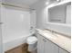 Clean bathroom with white vanity, bathtub, and updated flooring at 5670 S Lowell Blvd, Littleton, CO 80123