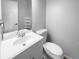 Clean bathroom with white vanity, toilet, and a large mirror at 5670 S Lowell Blvd, Littleton, CO 80123