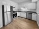 Kitchen with stainless steel appliances and light wood flooring at 5670 S Lowell Blvd, Littleton, CO 80123
