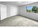 Bright bedroom with carpeting, large window, and spacious closet at 5670 S Lowell Blvd, Littleton, CO 80123