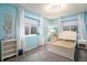 Relaxing bedroom with light blue walls, large windows, and a comfortable bed at 17859 E 108Th Pl, Commerce City, CO 80022