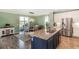 Modern kitchen with a large island and stainless steel appliances at 17859 E 108Th Pl, Commerce City, CO 80022