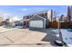 Two-story house with gray siding, red accents, and a long driveway at 12192 W Layton Ave, Morrison, CO 80465