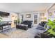 Spacious living room with gray couches and a large TV at 12192 W Layton Ave, Morrison, CO 80465