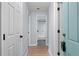 Hallway with light gray walls and wood-look flooring at 12525 E Tennessee Cir # E, Aurora, CO 80012