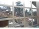 View of a deck and snowy landscape through a multi-paned window at 13927 Dancing Bear Trl, Littleton, CO 80127