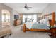 Bright and spacious primary bedroom with a wooden bed frame and large windows at 1661 Peninsula Cir, Castle Rock, CO 80104