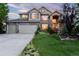 Two story house with three car garage and landscaped front yard at 1661 Peninsula Cir, Castle Rock, CO 80104