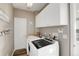 Bright laundry room with washer, dryer, and ample cabinetry at 1661 Peninsula Cir, Castle Rock, CO 80104