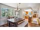 Bright dining area with wood table and bench, kitchen view at 1044 S Grapevine Rd, Golden, CO 80401