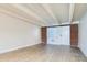 Spacious living room with laminate flooring and brick accent wall at 1180 Yosemite St # 110, Denver, CO 80220