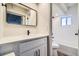 Modern bathroom with white vanity, black matte fixtures, and wave tile at 1180 Yosemite St # 110, Denver, CO 80220