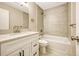Clean bathroom with a bathtub, updated vanity, and tile surround at 6885 E Arizona Avenue # D, Denver, CO 80224